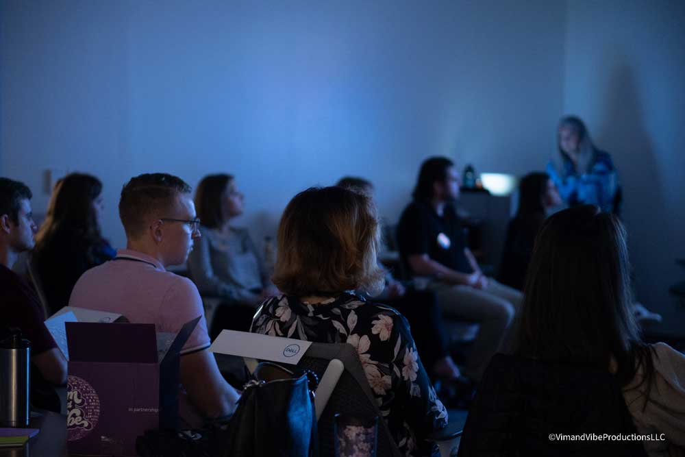 Audience watching presentation in dark room